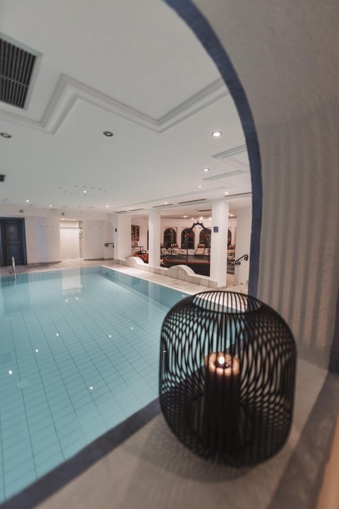 Pictures from Sportalm Indoor area with lit swimming pool and candle in decorative cage