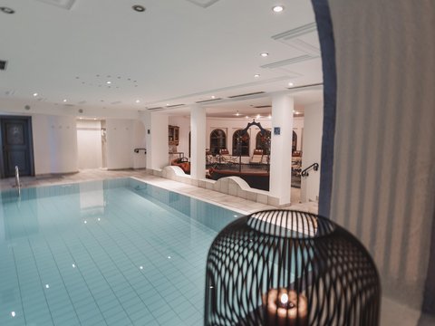 Pictures from Sportalm Indoor area with lit swimming pool and candle in decorative cage