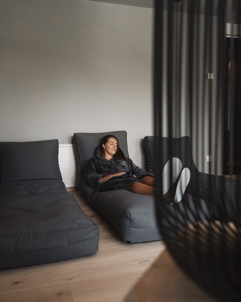 Pictures from Sportalm Woman relaxing on gray lounge chair in modern room