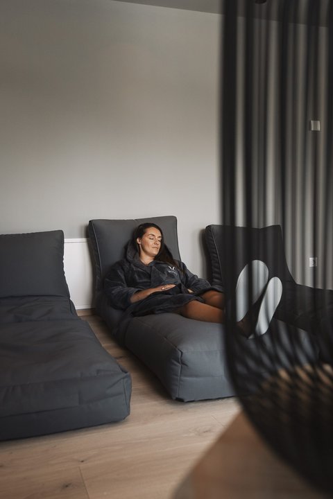 Pictures from Sportalm Woman relaxing on gray lounge chair in modern room