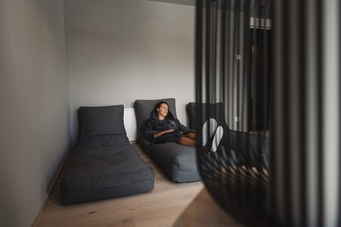 Pictures from Sportalm Woman relaxing on gray lounge chair in modern room