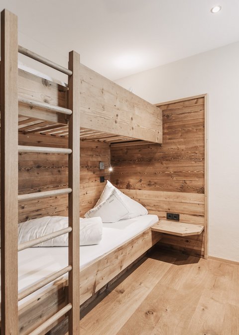 Pictures from Sportalm Small room with bunk bed and wooden paneling