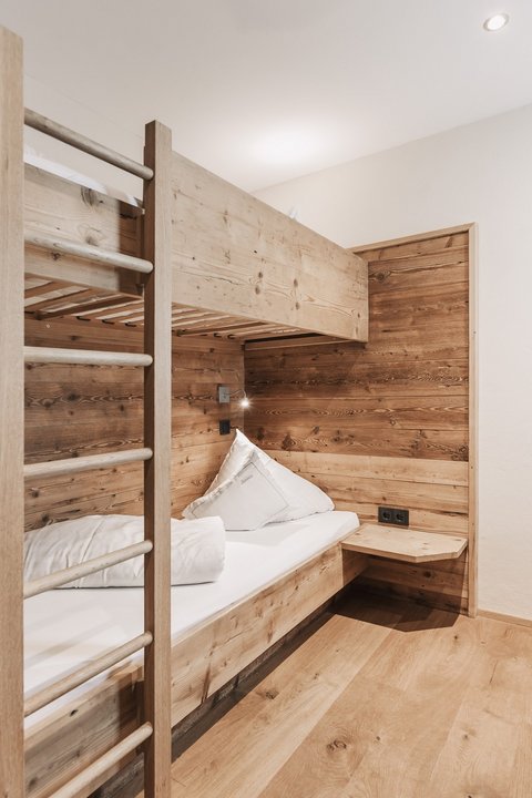 Pictures from Sportalm Small room with bunk bed and wooden paneling