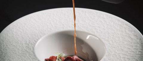 Pictures from Sportalm Sauce poured over gourmet garnish in a decorative white plate