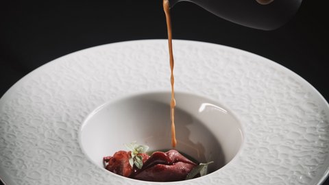 Pictures from Sportalm Sauce poured over gourmet garnish in a decorative white plate