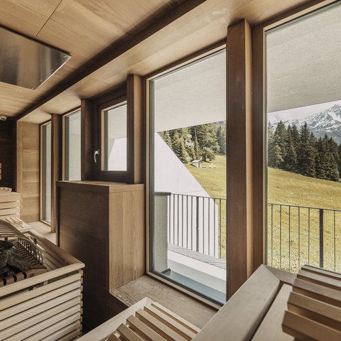 Pictures from Sportalm Sauna with large windows overlooking snow-capped mountain peaks