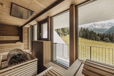 Pictures from Sportalm Sauna with large windows overlooking snow-capped mountain peaks