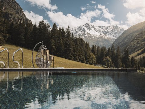 Pictures from Sportalm Pool with mountain view and hanging wicker chair on a sunny day