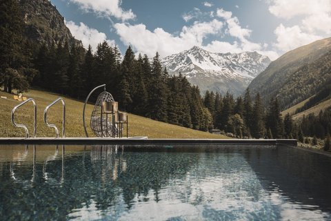 Pictures from Sportalm Pool with mountain view and hanging wicker chair on a sunny day