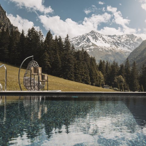Pictures from Sportalm Pool with mountain view and hanging wicker chair on a sunny day