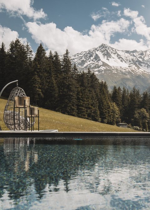Pictures from Sportalm Pool with mountain view and hanging wicker chair on a sunny day