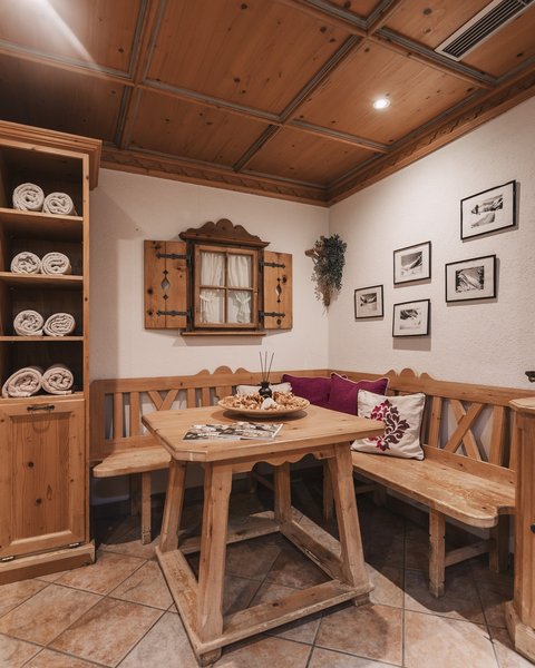 Pictures from Sportalm Cozy wooden corner with table, bench, and shelves filled with towels