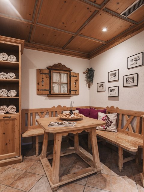 Pictures from Sportalm Cozy wooden corner with table, bench, and shelves filled with towels