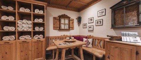 Pictures from Sportalm Cozy wooden corner with table, bench, and shelves filled with towels