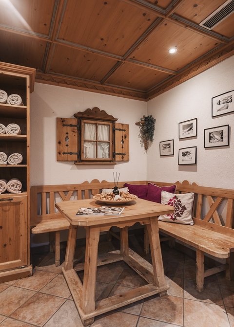 Pictures from Sportalm Cozy wooden corner with table, bench, and shelves filled with towels