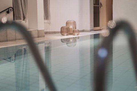 Bilder aus der Sportalm Innenpool mit Kerzen in dekorativen Laternen auf dem Boden