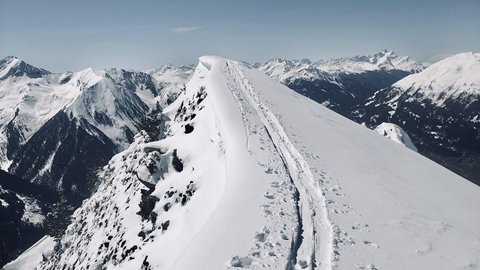 Pictures from Sportalm Snow-covered mountain peak with ski tracks under clear sky
