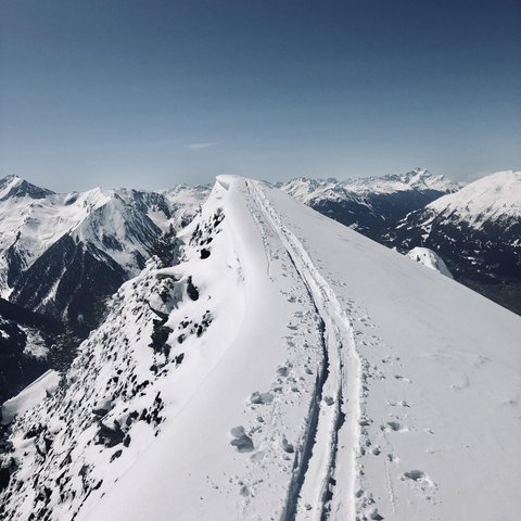 Pictures from Sportalm Snow-covered mountain peak with ski tracks under clear sky