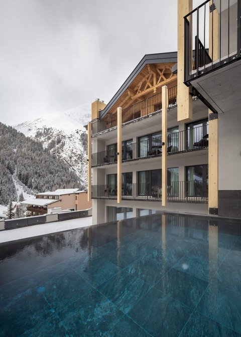 Pictures from Sportalm Modern lodge with pool and snow-covered mountains in the background