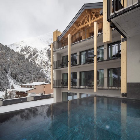 Pictures from Sportalm Modern lodge with pool and snow-covered mountains in the background