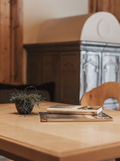Pictures from Sportalm Wooden table with books and plant in cozy room