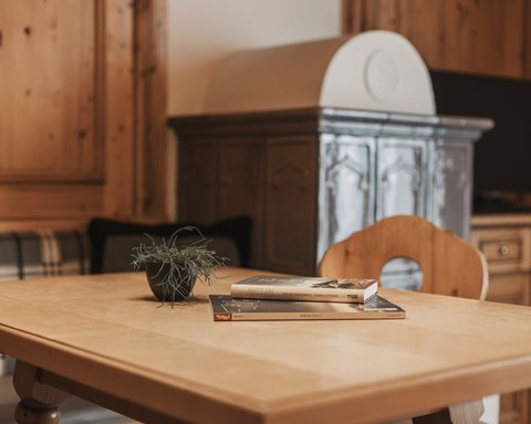Pictures from Sportalm Wooden table with books and plant in cozy room