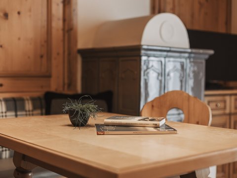 Pictures from Sportalm Wooden table with books and plant in cozy room