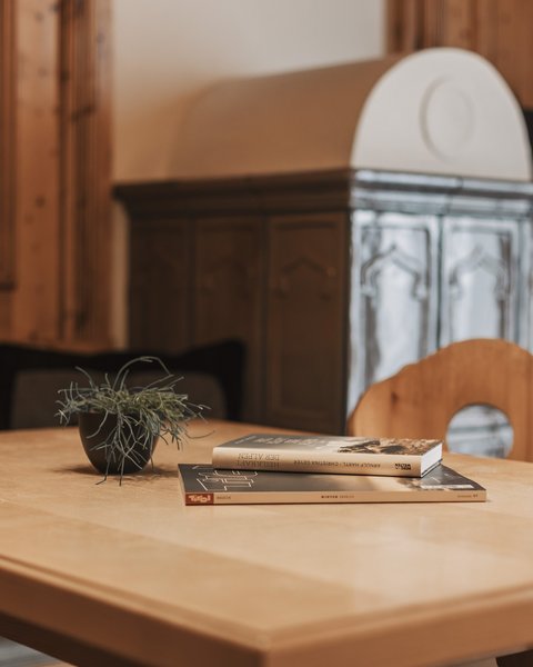 Pictures from Sportalm Wooden table with books and plant in cozy room