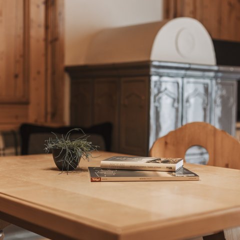 Pictures from Sportalm Wooden table with books and plant in cozy room