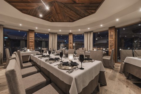 Pictures from Sportalm Elegant restaurant with set table and wooden accents under evening lighting