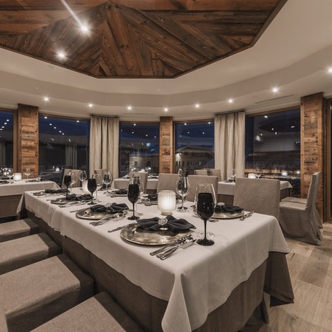 Pictures from Sportalm Elegant restaurant with set table and wooden accents under evening lighting