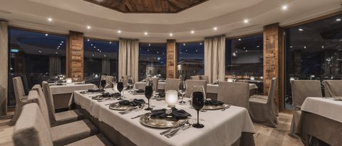Pictures from Sportalm Elegant restaurant with set table and wooden accents under evening lighting