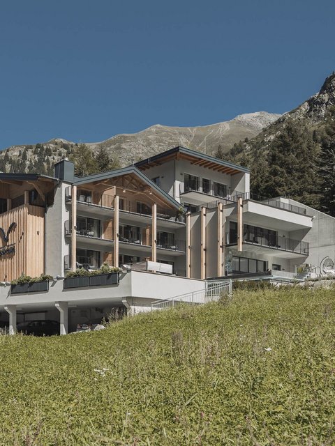 Pictures from Sportalm Modern hotel in mountains with green meadow and clear blue sky