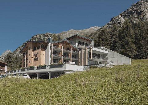 Pictures from Sportalm Modern hotel in mountains with green meadow and clear blue sky