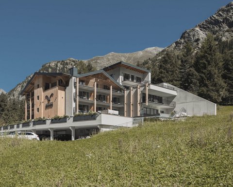 Pictures from Sportalm Modern hotel in mountains with green meadow and clear blue sky