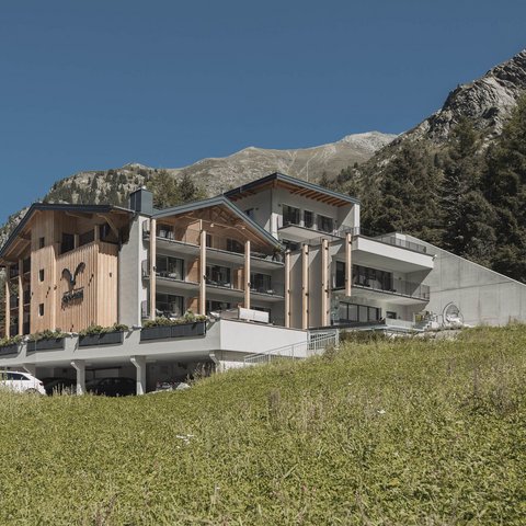 Pictures from Sportalm Modern hotel in mountains with green meadow and clear blue sky