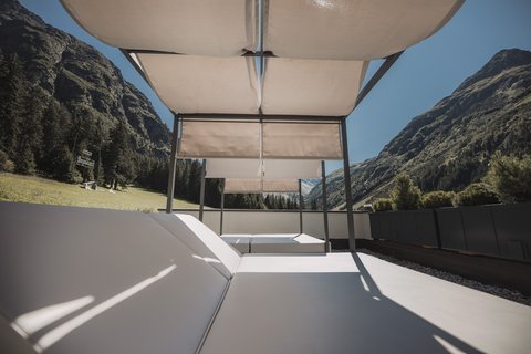 Pictures from Sportalm Sun loungers with canopy on terrace overlooking mountainous landscape under clear sky