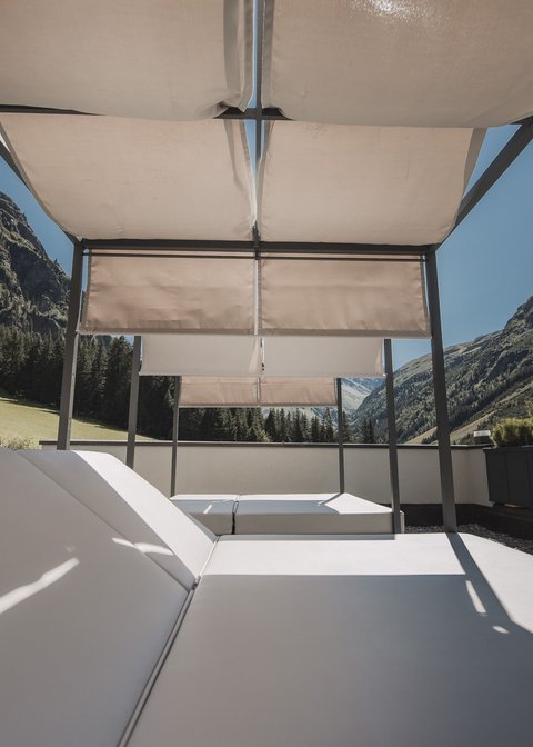Pictures from Sportalm Sun loungers with canopy on terrace overlooking mountainous landscape under clear sky
