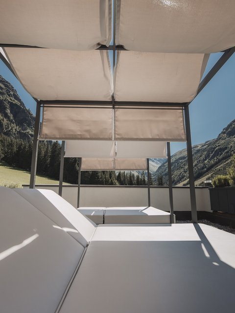 Pictures from Sportalm Sun loungers with canopy on terrace overlooking mountainous landscape under clear sky