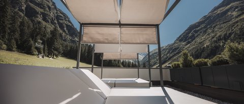 Pictures from Sportalm Sun loungers with canopy on terrace overlooking mountainous landscape under clear sky