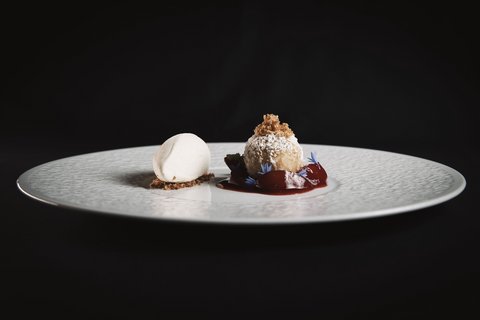 Pictures from Sportalm Elegant dessert with light ice cream and ball dusted with powdered sugar and red sauce