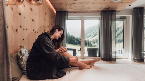 Pictures from Sportalm Woman in bathrobe relaxing in modern room with mountain view