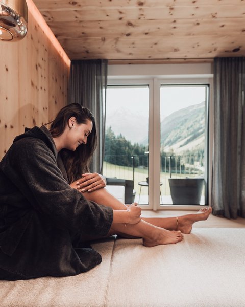 Pictures from Sportalm Woman in bathrobe relaxing in modern room with mountain view