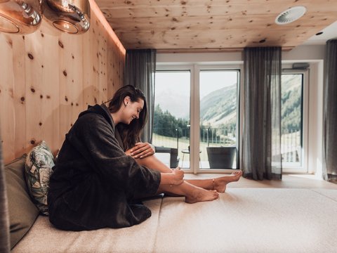 Pictures from Sportalm Woman in bathrobe relaxing in modern room with mountain view