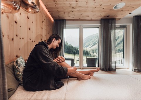 Pictures from Sportalm Woman in bathrobe relaxing in modern room with mountain view