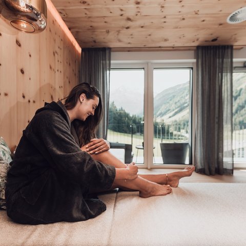 Pictures from Sportalm Woman in bathrobe relaxing in modern room with mountain view