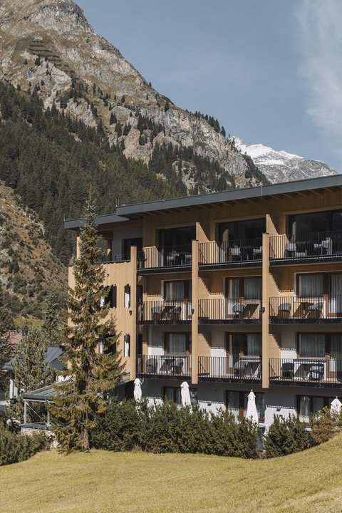 Pictures from Sportalm Hotel with balconies in front of forested mountain and snowy peaks