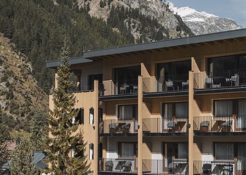Pictures from Sportalm Hotel with balconies in front of forested mountain and snowy peaks
