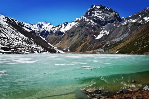 Pictures from Sportalm Frozen mountain lake with snow-capped peaks under clear blue sky