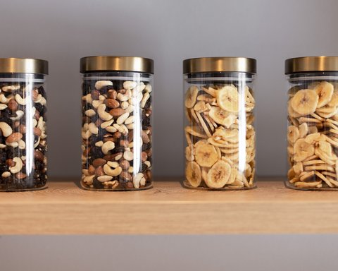 Pictures from Sportalm Four jars with nuts and banana chips on a wooden shelf